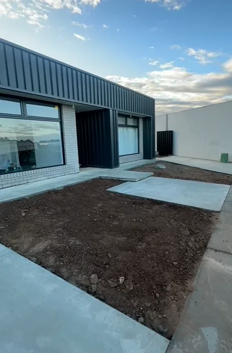 Plain grey concrete driveway and house surround